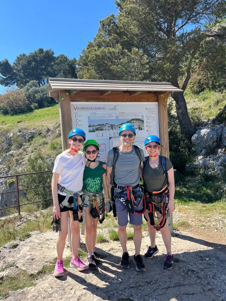 Group posing at the via ferrata start board before setting out.
